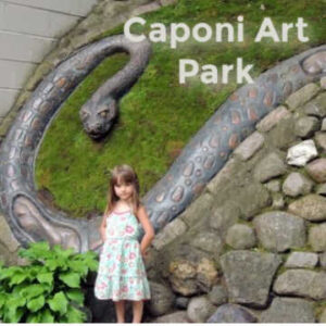 Girl in front of "Snake" sculpture by Anthony Caponi at Caponi Art Park in Eagan Minnesota
