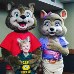 Boy posing with mascots at Great Wolf Lodge in Bloomington, Minnesota