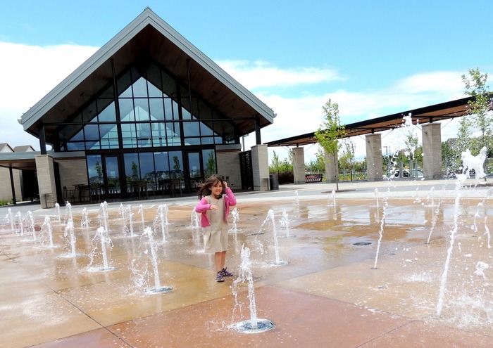 Girl paying in splash pad found at Central Park in Maple Grove Minnesota
