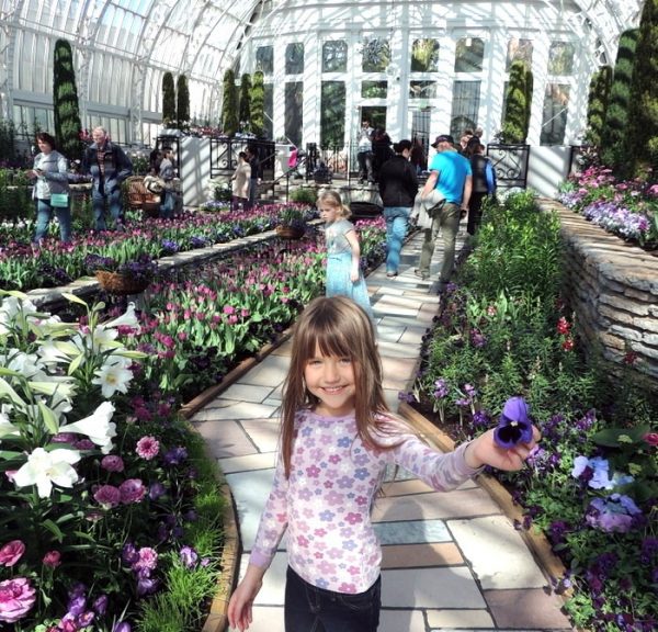 Young girl visiting the Como Conservatory in St. Paul, Minnesota