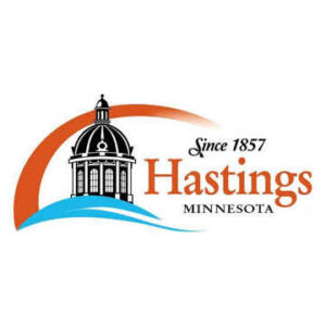 Hastings Minnesota Logo: Orange Arc and blue wave in front of a black lighthouse drawing "Since 1857 Hastings Minnesota"