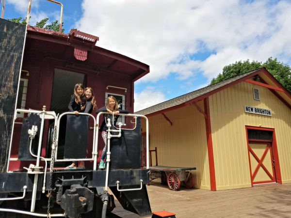 Kids on back of caboose at the New Brighton History Center in Minnesota