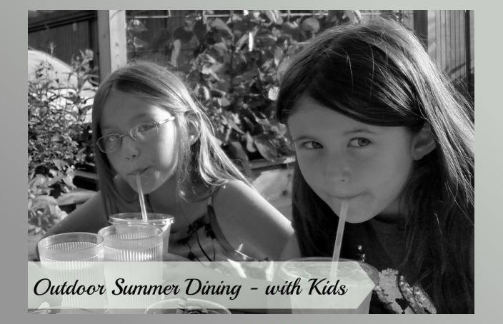 outdoor summer dining - with kids. Two girls dining outside.