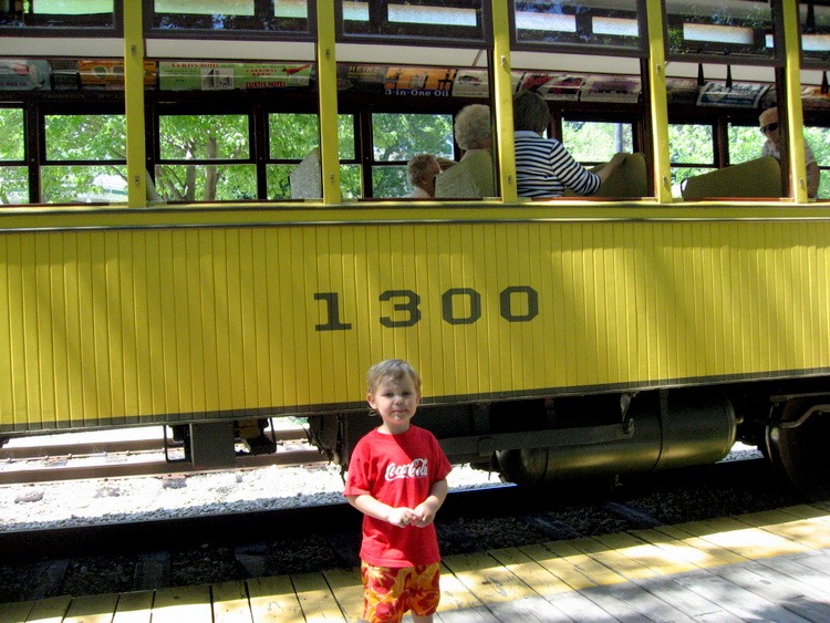 Old street car with boy in front