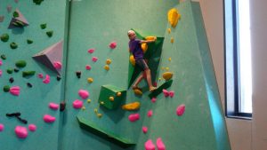 Girl climbing wall at the Minneapolis Bouldering Project