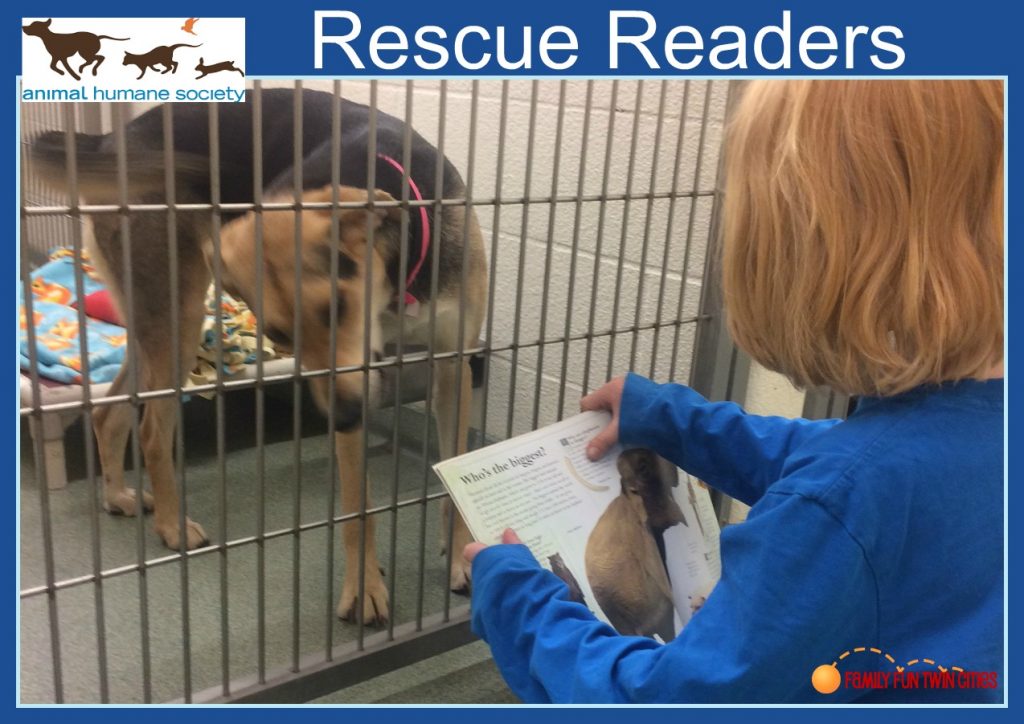Boy reading to a dog at the Animal Humane Society of Minnesota during the Rescue Readers Program