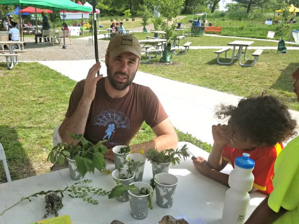 Volunteer teaching about gardening at Frogtown Farm Park in Saint Paul, Minnesota