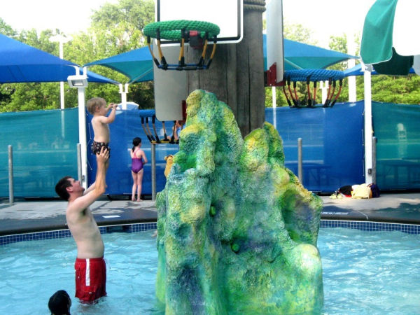 Father playing with toddler son at Highland Park Aquatic Center in Saint Paul, Minnesota