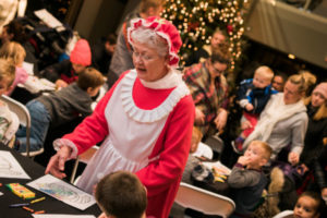 Mrs. Santa admiring art at the Here Comes Santa Claus event in downtown Rochester Minnesota