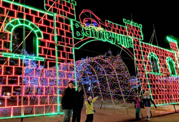 Kids standing at the entrance to of Bentleyville Holiday Lights in Duluth, Minnesota