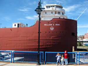 Small kids standing in front of the USS William A. Irvin in Duluth Harbor, Duluth, Minnesota