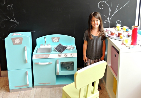Girl playing in toy kitchen at Amy's Cupcake Shoppe in Hopkins, Minnesota