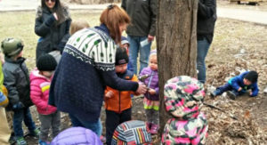 Families with small children learning about maple syruping at Westwood Hills Nature Center in Minnesota