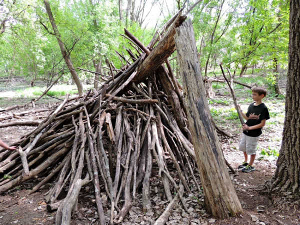 Boy building a fort in the Dodge Nature Center Play Area, South St. Paul, Minnesota
