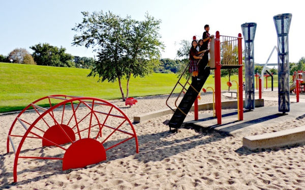 Three kids on playground equipment at Harriet Island Park in Saint Paul Minnesota