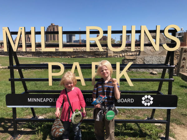 Two children in front of Mill Ruins Park sign in Minneapolis Minnesota