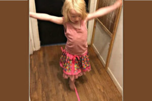 Girl walking on a Balance Beam made from pink tape - Indoor Games for Kids