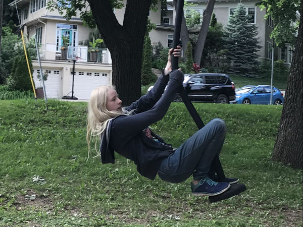 Girl playing on the zipline at Kenwood Park in Minneapolis Minnesota