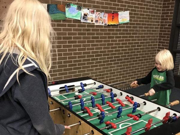 Two children playing Foosball at Kenwood Park Community Center in Minneapolis, MN