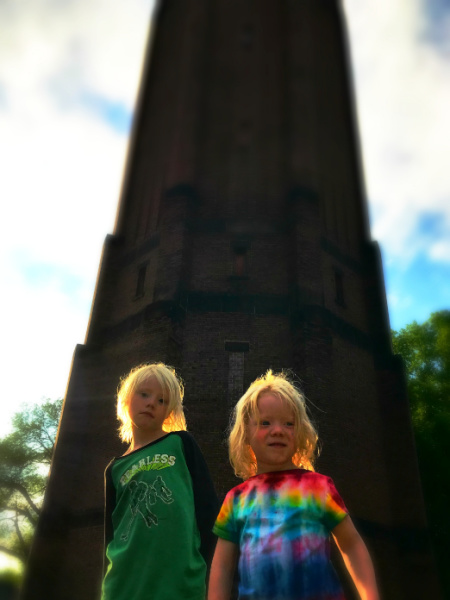 Two children standing in front of the Kenwood Tower in Minneapolis, Minnesota
