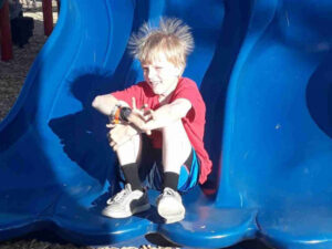 kid on slide at Kamp Dels Campsite in Waterville Minnesota
