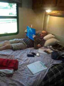 reading a book on camper bed
