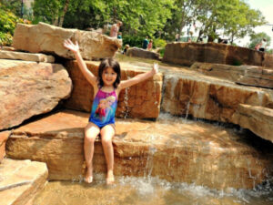 Girl playing in Nicollet Commons Park - Splash Pad in Burnsville, Minnesota