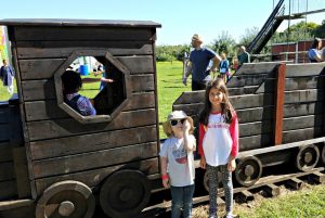 Children playing on a wooden train at Croix Farm Orchard in Hastings, Minnesota