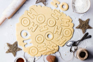 christmas cookie dough rolled out with letters H & O cut out