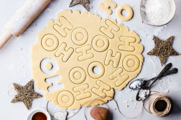 christmascookie dough rolled out with letters H & O cut out