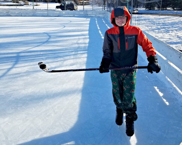 Boy practicing hockey on an outdoor rink in Saint Paul, Minnesota