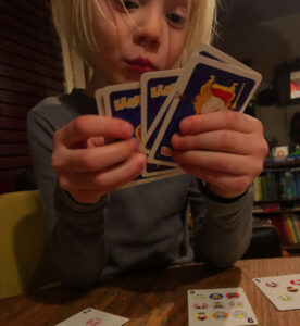 Boy playing the card game, Llama Drama
