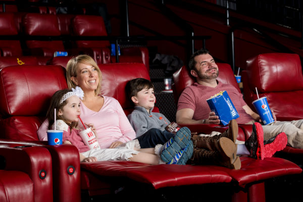 Family enjoying movie at Marcus Theatre