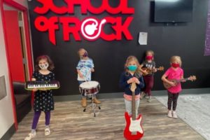 Masked children participating in School of Rock Rookies Camp