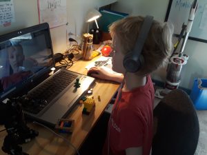 Boy and legos at computer