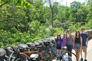 family taking a break from biking the Minnehaha Falls bike trail in Minneapolis, Minnesota
