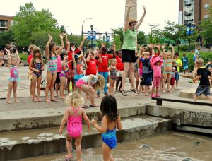 Kids dancing at a Rockin Lunch Hour Performance at Nicollet Commons Park in Burnsville, MN