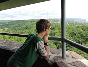 Boy looking out over Duluth Minnesota from the top of Enger Park Tower.