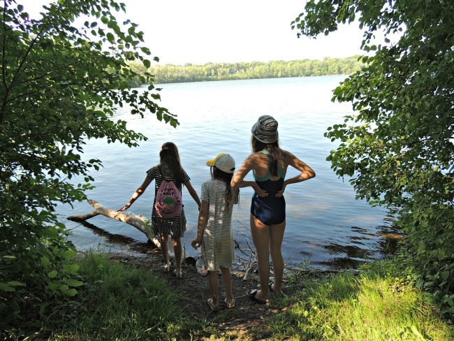 Three girls wading at Cedar Lake Park in Minneapolis