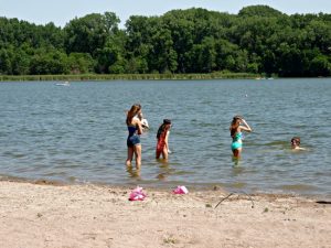 Kids swimming at Cedar Lake Point Beach in Minneapolis, MN