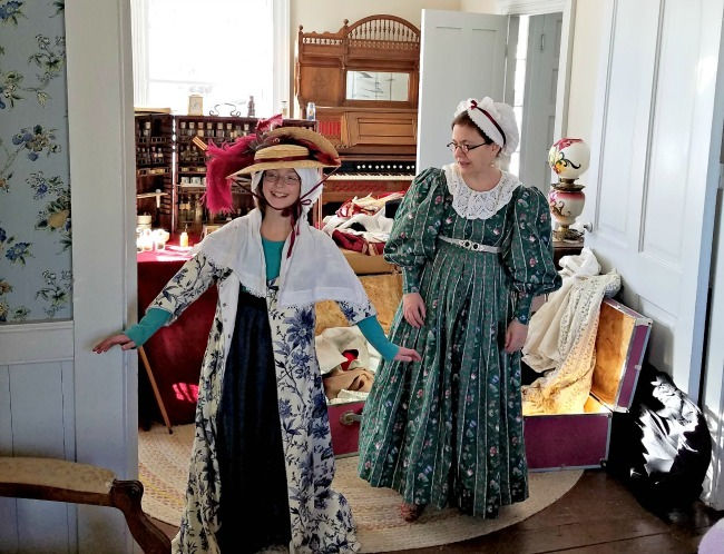 Trying on clothes from the 1900s at a Sunday Open House at Pond-Dakota Mission Park