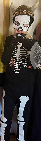 Boy dressed as skeleton for Halloween.