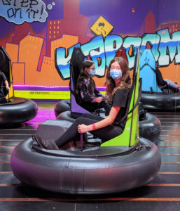 girls playing on bumper cars at Grand Slam Sports