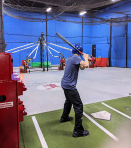 Boy practicing hitting at the Grand Slam Sports batting cages, Burnsville, MN