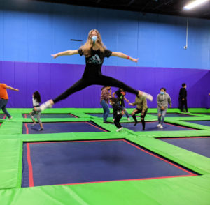 Girl jumping on trampolines at Grand Slam Sports