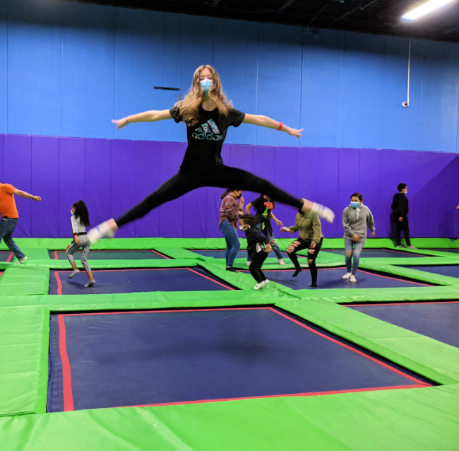 Girl jumping on trampolines at Grand Slam Sports