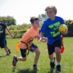 three boys playing Flag Football with AKASport
