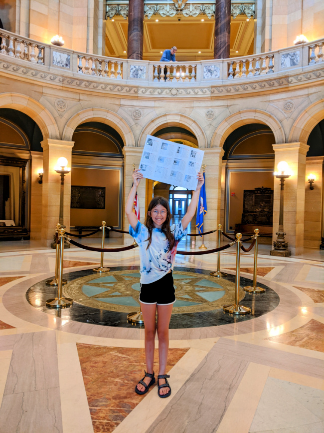 Girl showing her Art Treasures Scavenger Hunt at the Minnesota State Capitol in St. Paul, MN