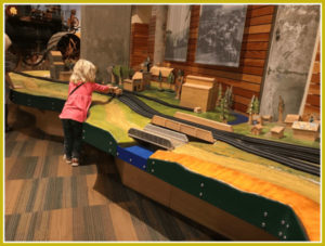 Little Girl playing with train table at Mill City Museum in Minneapolis, Minnesota