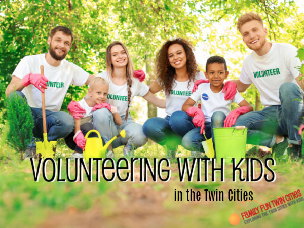 Volunteering with Kids Kids and adults posing with garden tools